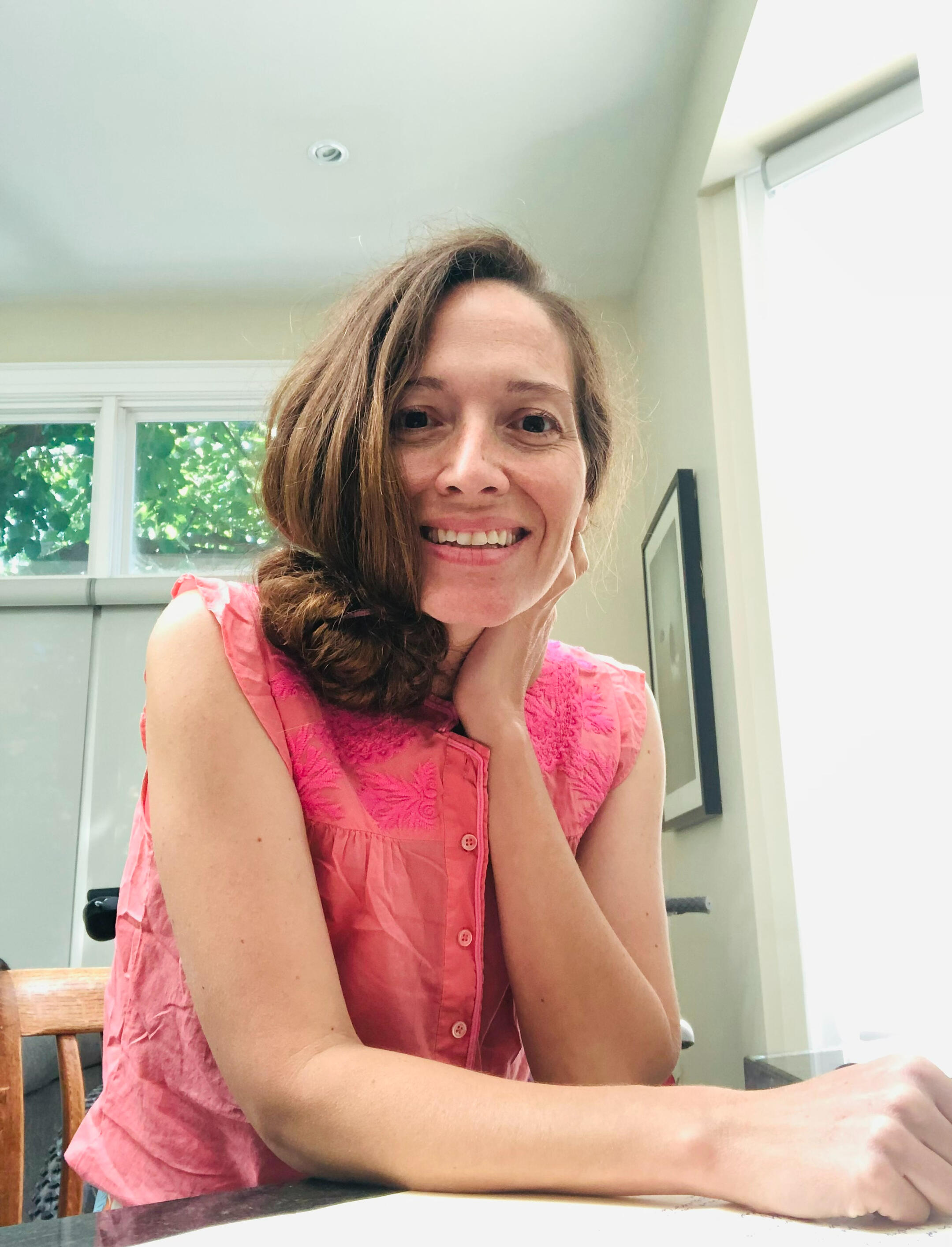 Jill smiling in a bright indoor setting